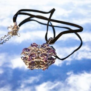 Handmade, silver, purple tone metal pendant in a Celtic design.